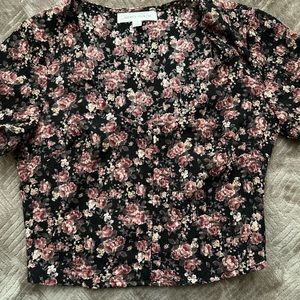 A small crop floral blouse with corset button ups & scoop neck/short sleeves